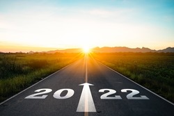 New year 2022 or start straight concept.word 2022 written on the road in the middle of asphalt road at sunset.Concept of planning and challenge or new life change,business strategy,opportunity,hope