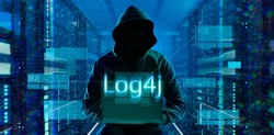 cybersecurity vulnerability Log4J and hacker,coding,malware concept.Hooded computer hacker in cybersecurity vulnerability Log4J on server room background.