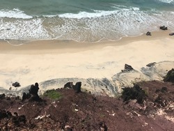 Eroded cliffs and sand on the beach