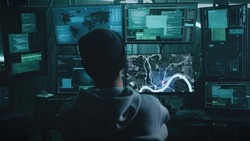 Teenage hacker with glasses watching a car on a monitor and pressing a keyboard in a dark cybercriminal hideout with lamps during a cyberattack