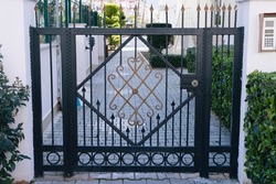 Metal wrought gates in a multi-storey complex.Worn iron. Metal fence