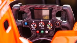Racing car steering wheel.  Detailed view of an open-wheel single-seater formula racing car.