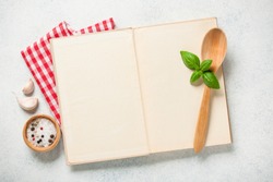 Cooking concept with cookbook on kitchen table