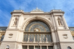 Main facade of the Budapest Keleti Palyaudvar train station during a sunny afternoon with the mention Budapest Keleti Palyaudvar in hungarian meaning Keleti Train station. 

