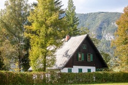 Residential house, slovenian chalet building, in the middle of a mountain glade, a clearing in the middle of a forest of the julian alps in Slovenia, in Stara Fuzina, Triglav national park, in Bohinj