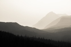 Black and white forest and mountains in smoke from a forest fire