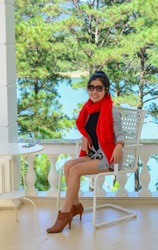 A young Asian woman sitting at luxury villa in Dalat, Vietnam.