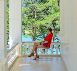 A young Asian woman sitting at luxury villa in Dalat, Vietnam.
