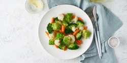 Mix of boiled vegetables. Broccoli, carrots, cauliflower. Steamed vegetables for dietary low-calorie diet. FODMAP, dash diet, vegan, vegetarian, top view