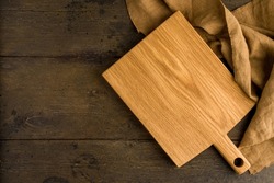 Bamboo lightweight chopping board overhead food background, linen napkin. Kitchenware for cooking and preparation. Sturdy surface to prep on. Horizontal, copy space