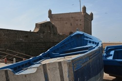 Morocco, Essaouira - blue boats in front of the fortress