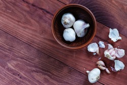 Sliced Garlic and garlic bulb on vintage wooden background. Place for text, copy space. Concept of healthy food.