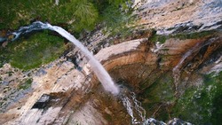 ascending shot of a huge marvelous waterfall in Georgia, Okatse Canyon. High quality photo
