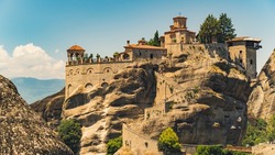 One of the most famous Greek places for tourists interested in religion, architecture, and nature. Stunning building complex of Meteora monastery placed on rock formation. High quality photo