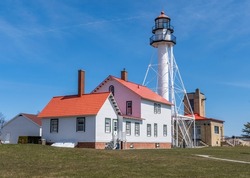 Whitefish Point Lighthouse during a sunny spring morning in the Upper Peninsula of Michigan along Lake Superior. 