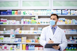 Pharmacist selling medicines in pharmacy shop during corona virus pandemic. Healthcare and medicine.