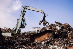 Industrial scrap metal recycling in junkyard.