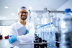 Portrait of an experienced caucasian technologist working in bottling factory producing drinking water.