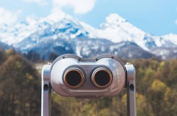 touristic telescope look at the city with view snow mountains, closeup binocular on background viewpoint observe vision, metal coin operated in panorama observation, travel nature concept