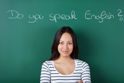 smiling female student in classroom learning english