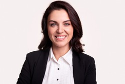 Happy successful adult business lady in formal black jacket and white shirt looking at camera and smiling against white background