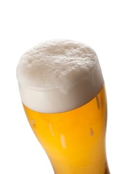 Light beer in a glass close-up, foamy beer