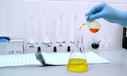 Laboratory of chemical analysis .A woman 's hand in a blue medical glove makes an analysis of drinking water . The concept of science and chemistry