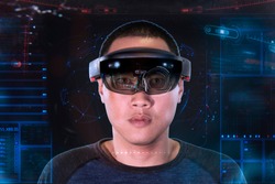 Portrait of young asian man with 3D virtual reality glasses microsoft hololens | VR panel like Iron Man