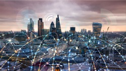 City of London at sunset with communication icons and network lines