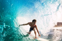 Surfer on Blue Ocean Wave Getting Barreled