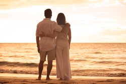 Romantic Mature Couple Enjoying at Sunset on the Beach in Hawaii