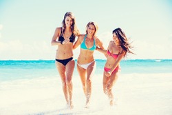 Group of Three Beautiful Attractive Young Women Walking on the Beach
