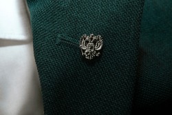 Badge with a Russian double-headed eagle on the lapel of the jacket, Russian symbols