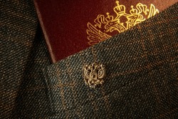 Badge with a Russian double-headed eagle on the lapel of the jacket, Russian symbols, Russian passport