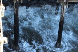 Ocean waves hitting against the pier
