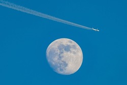 Flying plane over the Moon.