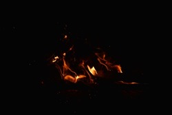 Small flames from a bonfire at night