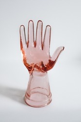 vintage pink glass hand, ring model, holder isolated on white