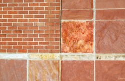 Red sandstone wall background with bricks and larger panels of stone