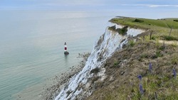 White chalk cliff aerial view of the the Beachy Head Lighthouse, in Eastbourne, East Sussex, England