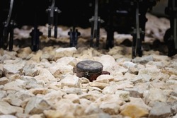 A anti-personnel mine on the rocks. Mine clearance using armored mine clearance vehicle.
