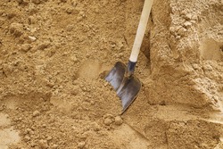 Soil with shovel, teel shovel be used for scoop sand to construct the building background, front view, Sharp shovel on cultivated farm field, Digging soil, Shovel putted into heap of ground