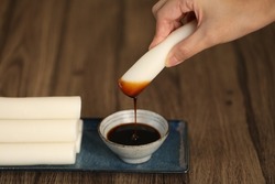 Tteok, Garaetteok, Bar rice cake, Korean traditional food with hand dipping in the black syrup, Jocheong 