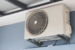 To cool the room, a split type inverter air conditioner condenser is connected to the smart air conditioner. Split type inverter air conditioner condenser is outside the house - Close-up shot