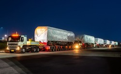 heavy oversize cargo truck Loading a new locomotive port area