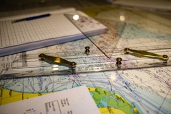 Nautical chart, parallel ruler and triangle close up detail