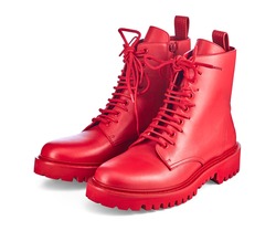 Beautiful pair of high red leather boots on lace and a massive sole with a rough tread, isolated on a white background with a shadow. Trend of the season: brightness and uniqueness of the image.