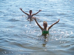 children swim and having fun in the river