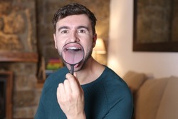 Man using magnification glass on tongue