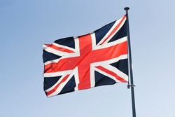 Great Britain flag waving in the wind on a sunny day.